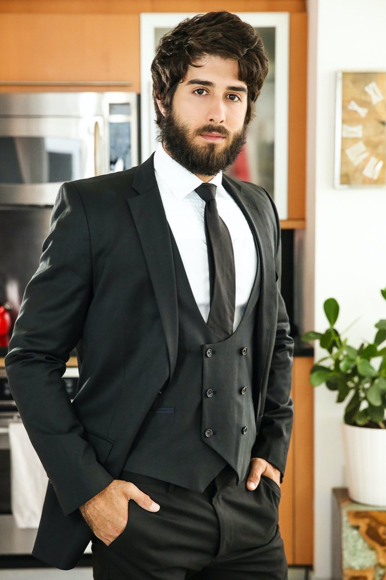 A high-resolution portrait of Diego Sans featuring his signature black hair, groomed facial hair, and intense brown eyes, showcasing his charismatic Brazilian features and athletic build.