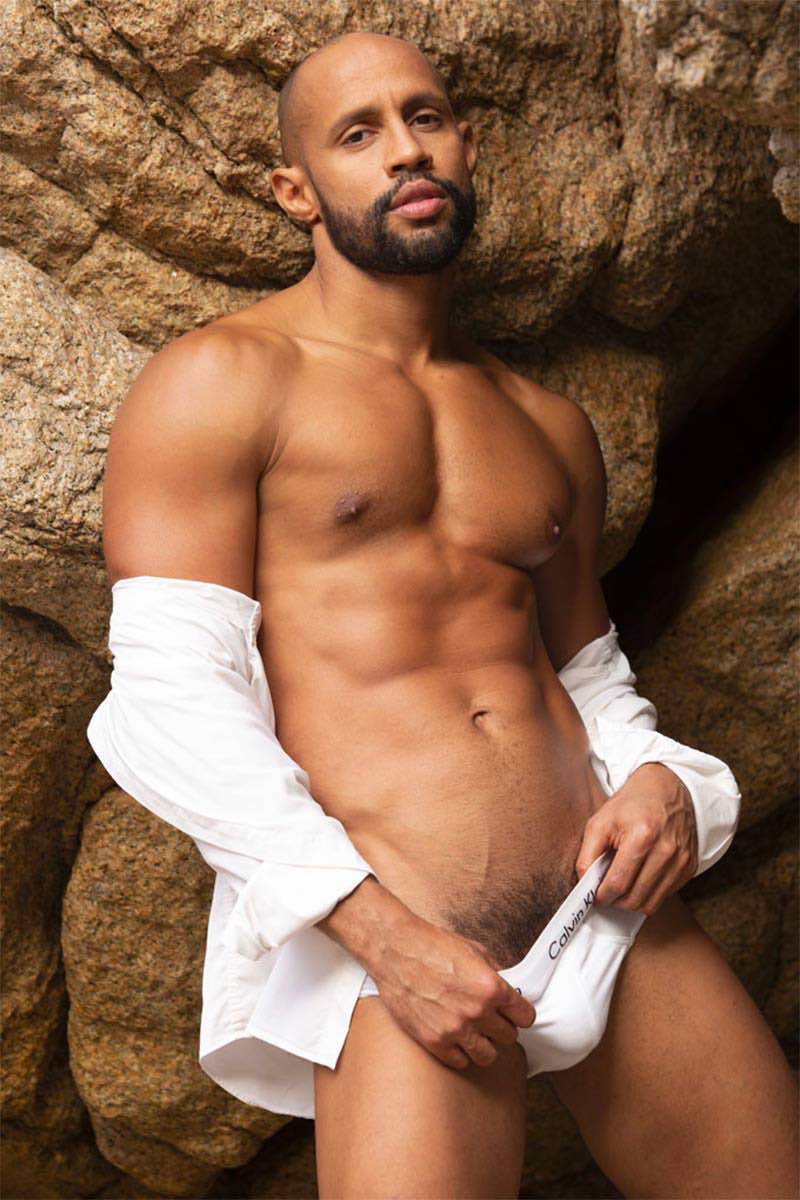 Harold Lopez professional portrait showcasing his athletic Latino build and confident gaze in a high-fashion studio setting